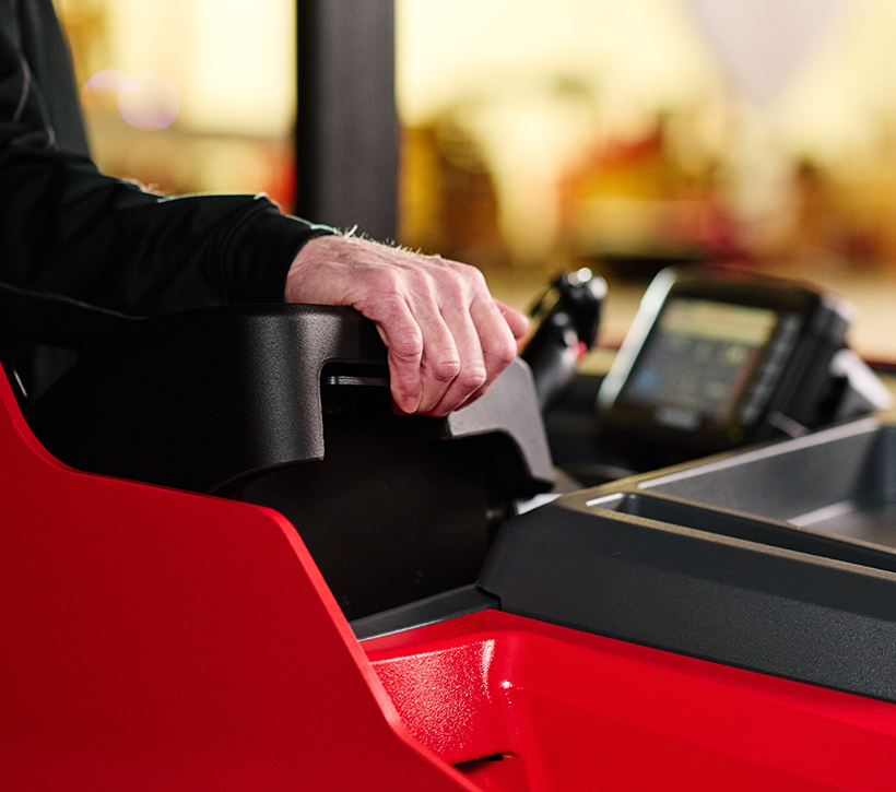 Adjustable armrest on Raymond stand-up counterbalanced forklift designed for ergonomic comfort for operators of different sizes