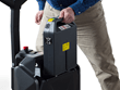 Person changing battery on walkie pallet jack. 